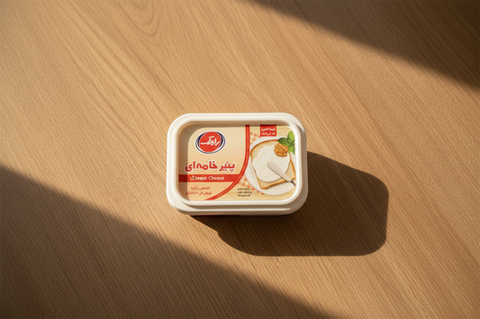 Person spreading cream on a dessert with a container of cream