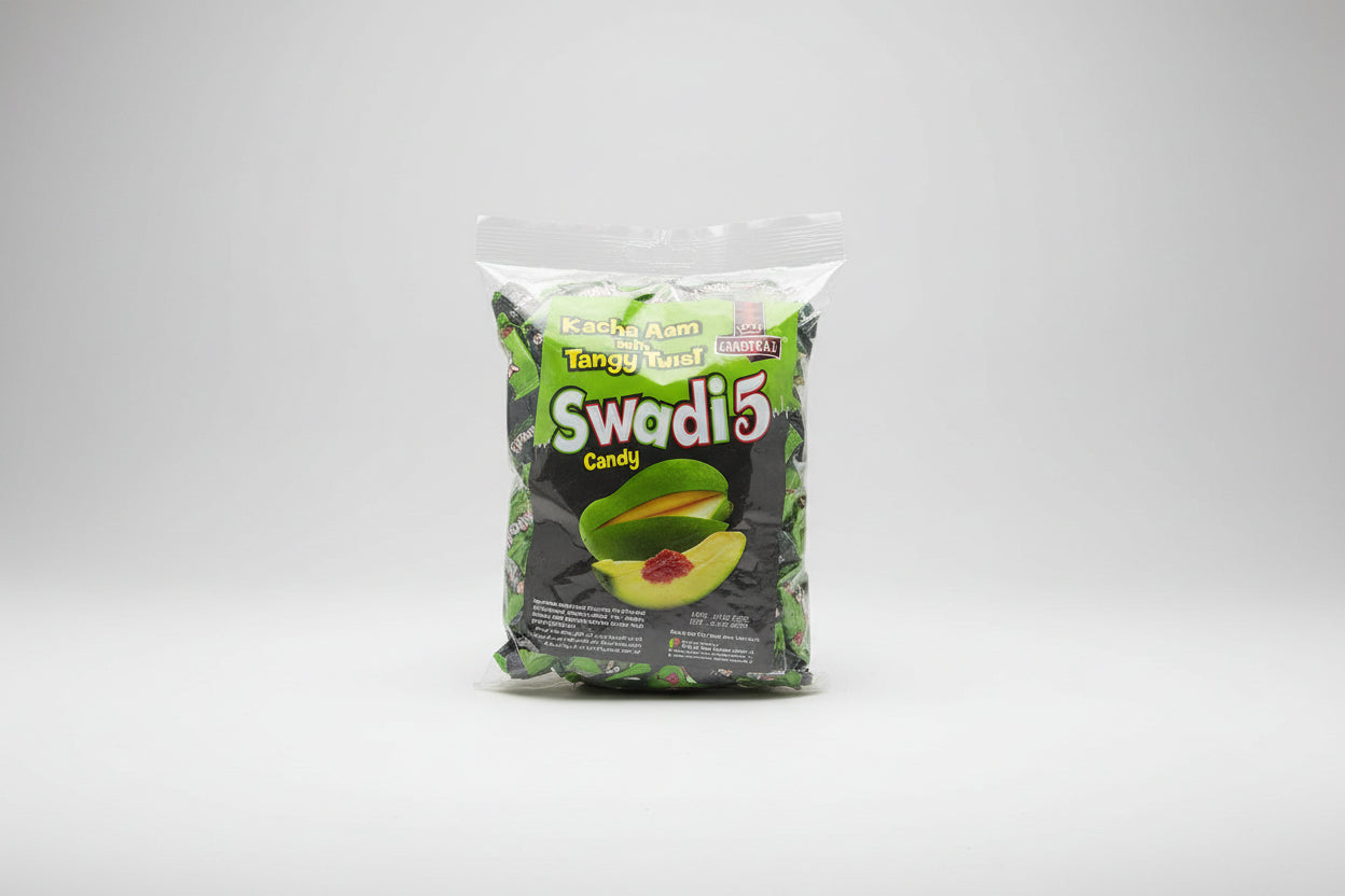 Packaged candy labeled 'Kacha Aam' with 'Swadi 5' branding on a textured surface.