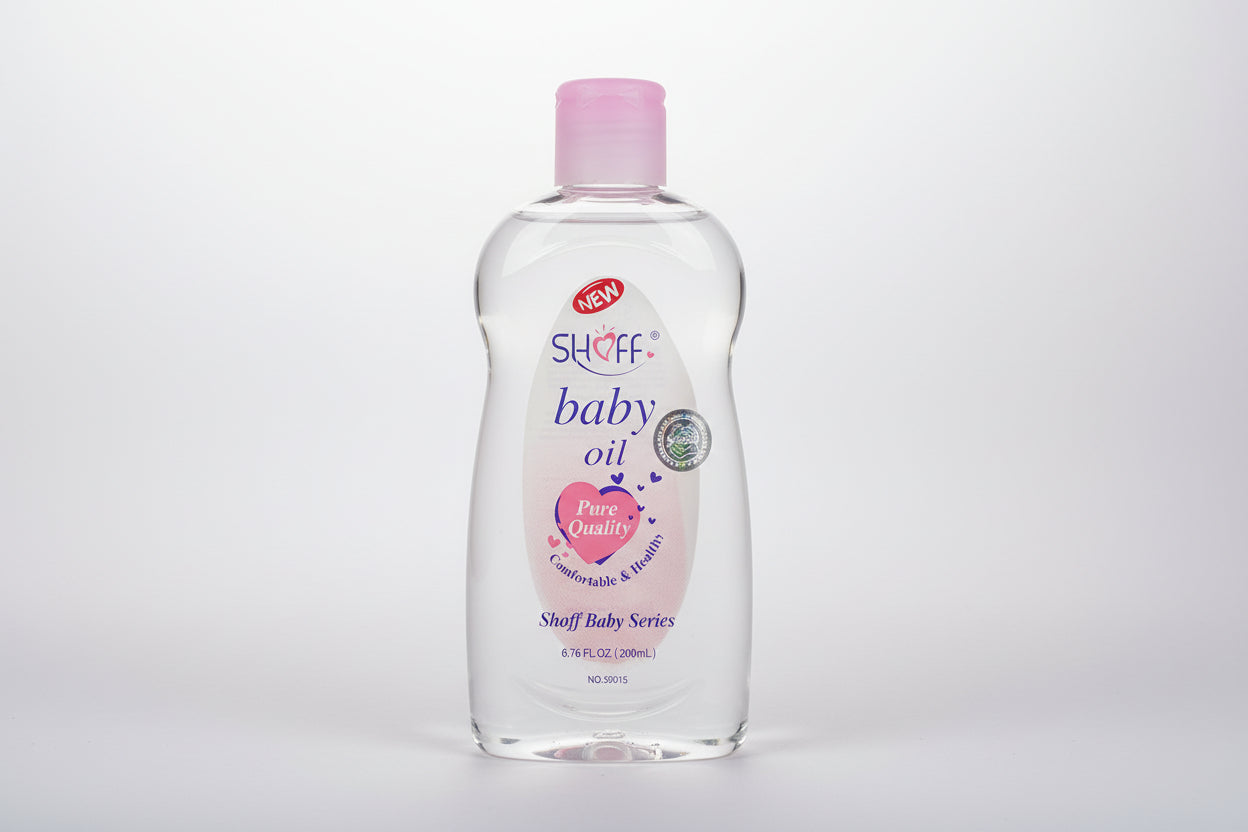 Two bottles of Shoff baby oil with pink caps on a shelf.