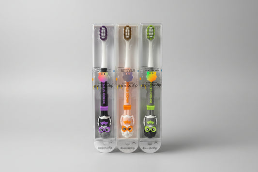  toothbrushes with colorful handles in clear packaging.